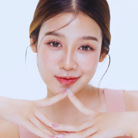 Woman with Pinkalulu Lip oil against a light background