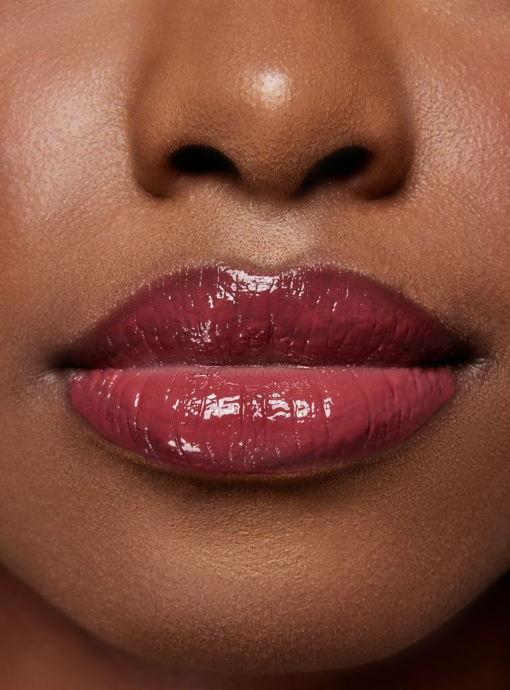 Close-up of a woman's lips wearing Pinkalulu tint lip oil.