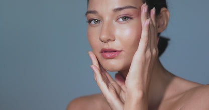 A woman touching her face with Pinkalulu pocket beauty lock glow